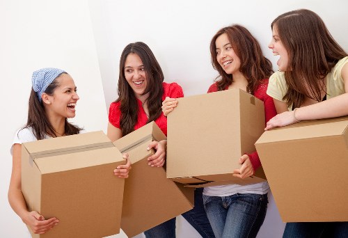 Professional movers handling bulky furniture in a Brompton home