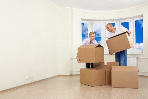 Removal team planning a local move in Brompton with packed boxes