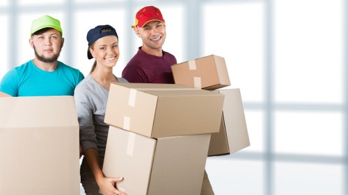 Loading household furniture into a moving truck in Brompton