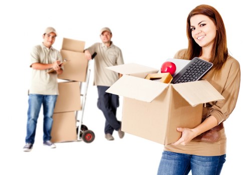 Furniture and boxes being loaded into a van for transport