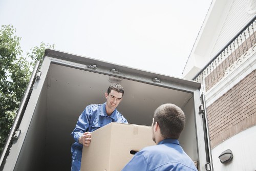 Local moving team loading furniture into a van near Brompton